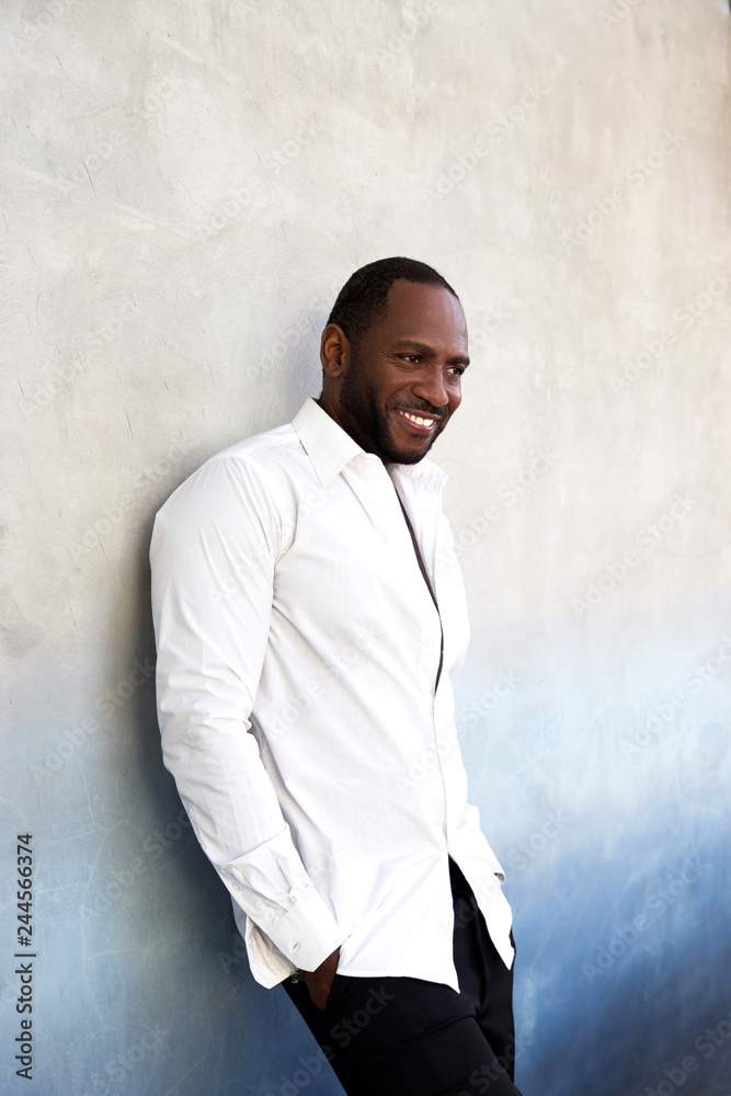Handsome cheerful african american man in white shirt standing. Handsome cheerful african american man in white shirt standing.