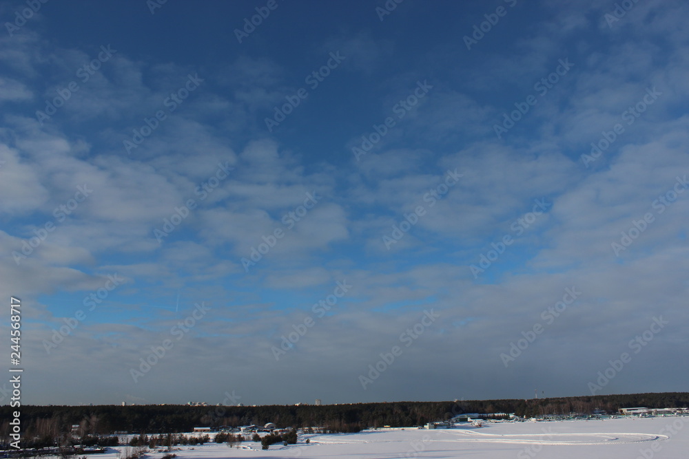 blue sky and white clouds on a Sunny winter day. the traces of the planes