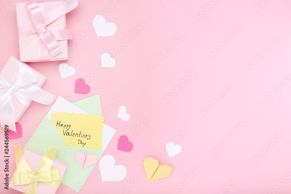 Inscription Happy Valentine Day with gift boxes and envelope on pink background