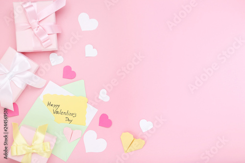 Inscription Happy Valentine Day with gift boxes and envelope on pink background © 5second