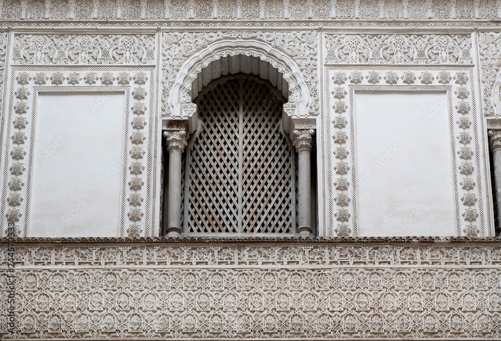 Window with shutter at front of the 14th century Alcazar royal palace, Mudejar architecture style