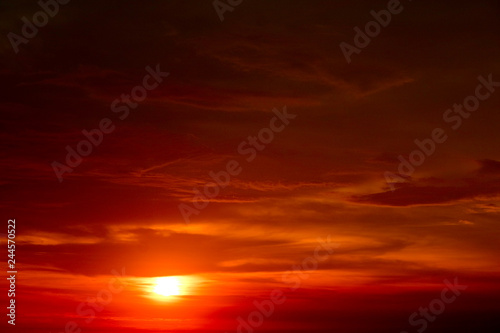 last light of sunset on the red cloud orange sky and ray around sun © darkfoxelixir