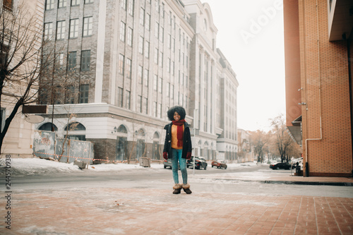 Young black woman is walking to the street. © Stanislav