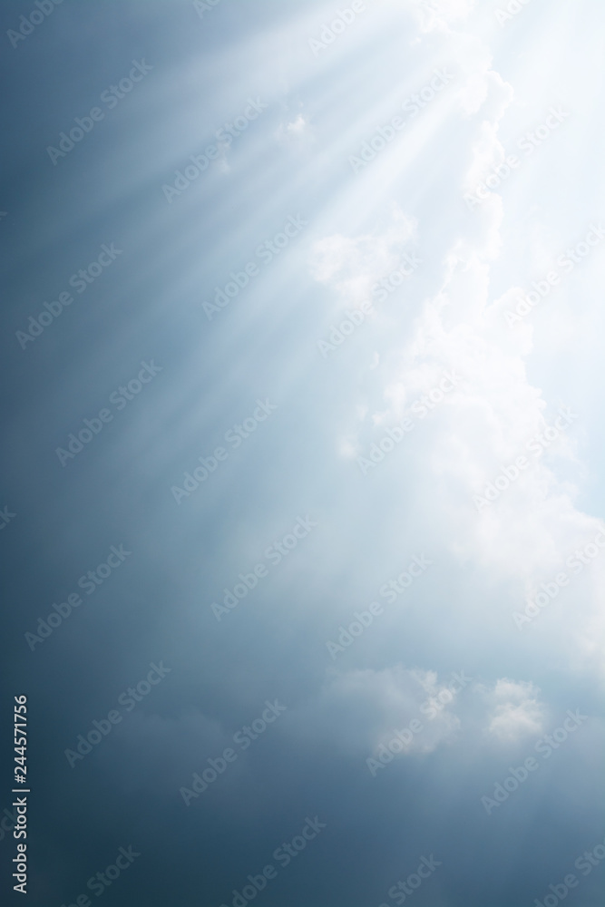 Fototapeta premium Rays of light come through the dark clouds before the rain