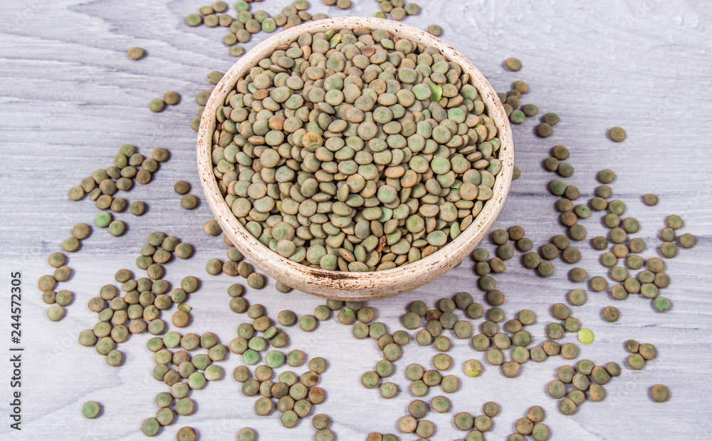 Green lentils - legume seeds with a high content of vegetable protein. Conception of healthy eating. Green lentils - legume seeds with a high content of vegetable protein. Conception of healthy eating.