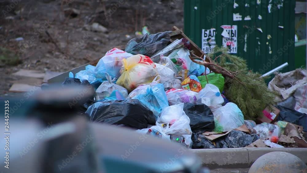 Closeup huge dump of garbage bags with waste lying on ground next to