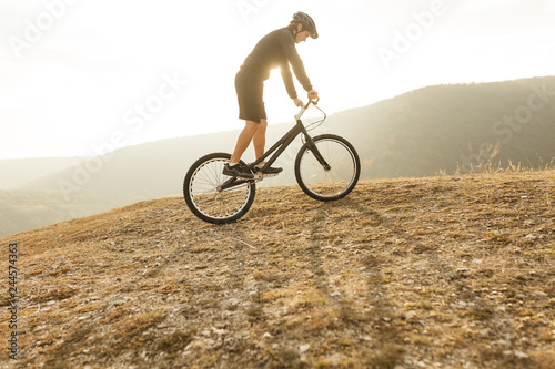 Young athlete on bicycle in countryside