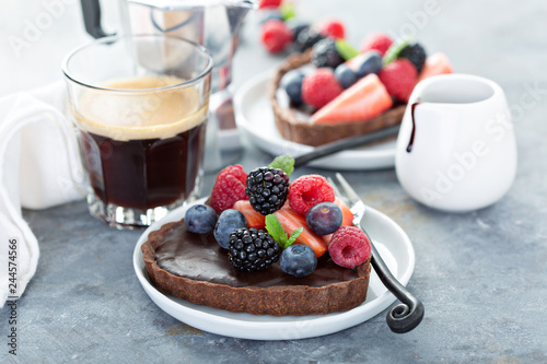 Chocolate heart tarts with ganashe filling and fresh berries photo