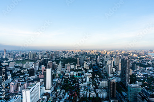 Sunset scene of Bangkok skyline with skyscraper and curve of Chao Praya river in the far background with Bokeh effect for nightlife concept / Cityscape concept / Nightlife