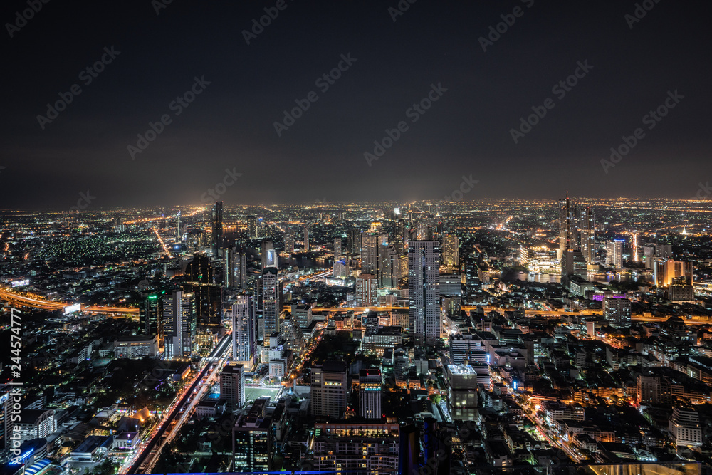 ฺNight scene of Bangkok cityscape with skyscraper and curve of Chao Praya river in the far background with Bokeh effect for nightlife concept / Cityscape concept / Nightlife