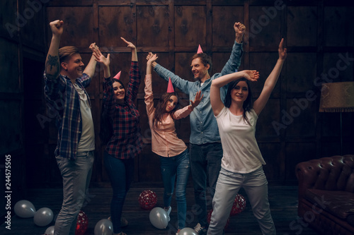 Group of friends dance at birthday party