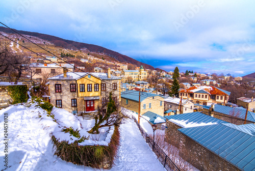 View of traditional stone buildings and streets with snow at the famous village of Nymfaio near Florina, Greece.  photo