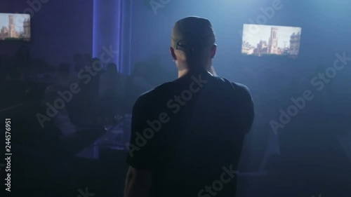 young man is reading rap on the stage. A Young Man Under The Spotlight With The Rap Scene