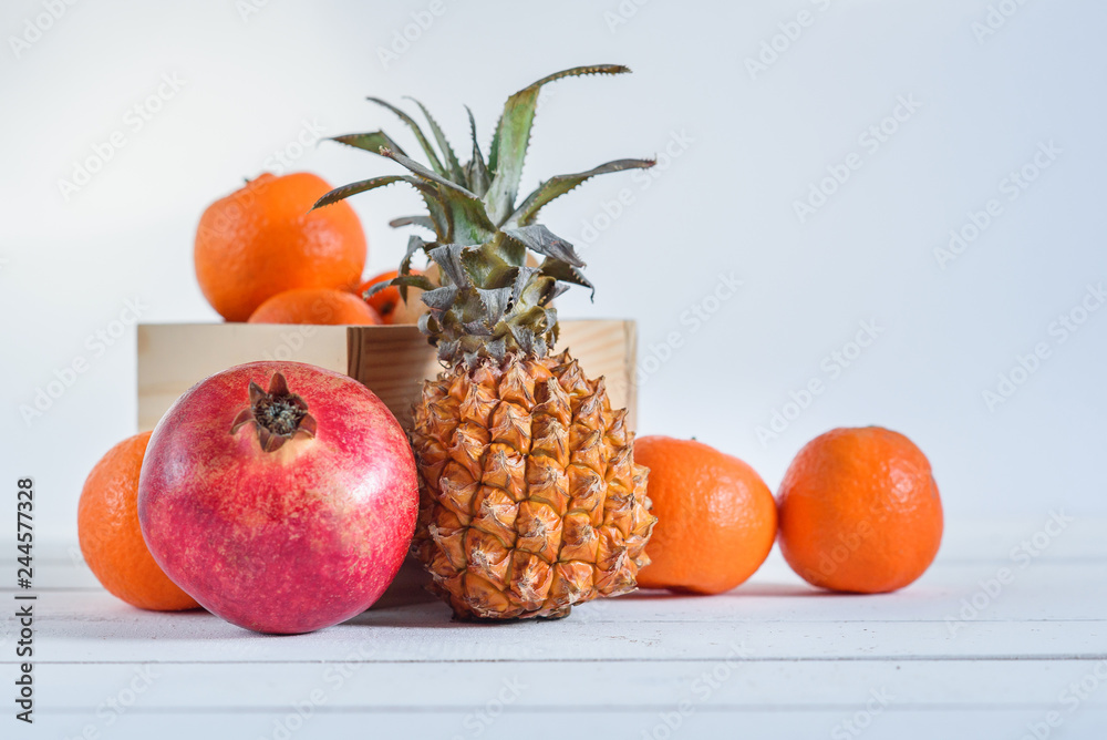 Group of fresh tropical fruits in small wooden box. Group of fresh tropical fruits in small wooden box.