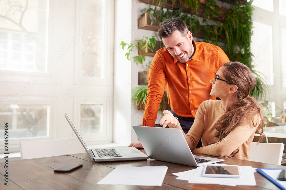 Group of business people working together on laptop in the office