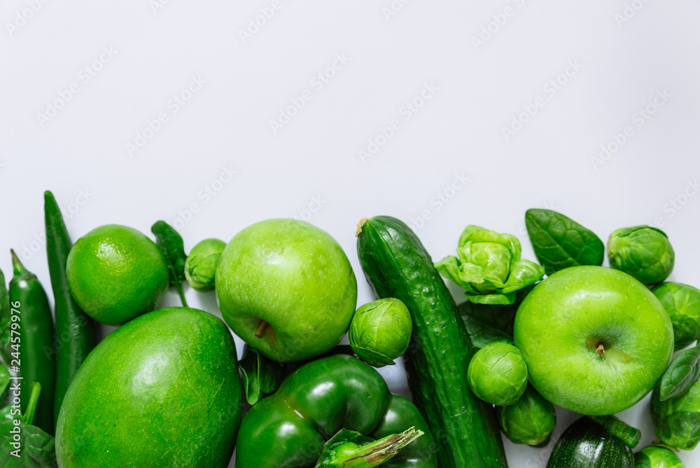 green fruits and vegetables on white background with copy space on top green fruits and vegetables on white background with copy space on top
