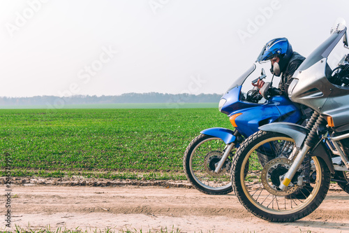 Two Motorbike and motorcyclist on off road  enduro  extreme mood  active lifestyle  adventure touring concept  outdoor trailway  dual sport. discover the world on motorcycle