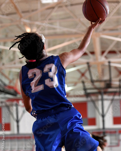 Canvas Print High School athlete making a layup during a basketball game