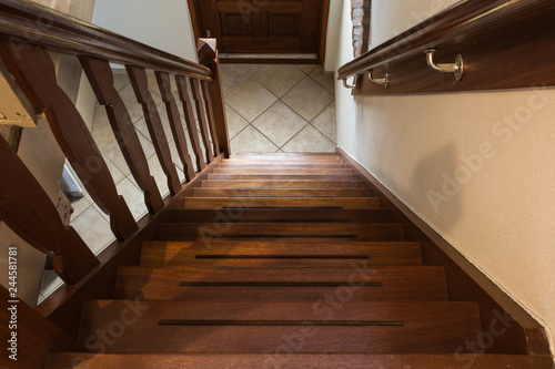 Modern brown oak wooden stairs, view from top, classic home style