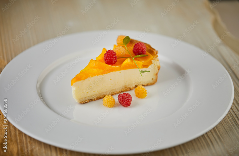 A slice of Cheesecake served with berries A slice of Cheesecake served with berries