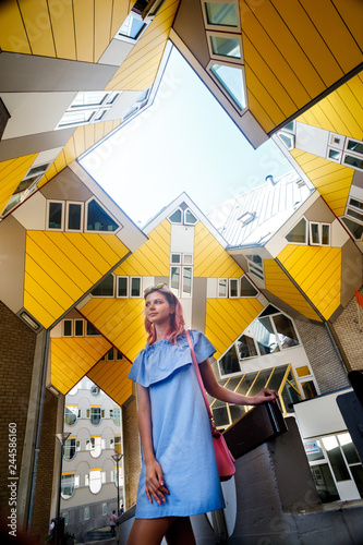 the girl on the background of the cube house or Kubuswoningen in Dutch are a set of innovative houses designed by architect Pete Blom and built in Rotterdam