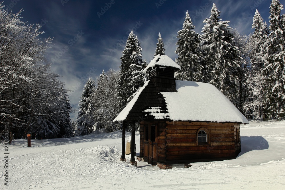 Wooden chapel in a popular ski and cross-country ski resort Paprsek in the Golden mountains (Czech: Rychlebske hory), Czech Republic.