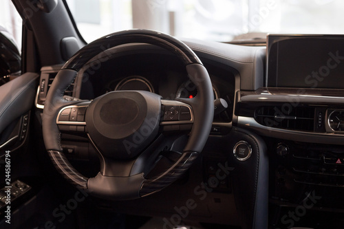 Interior of new modern car. Steering wheel and dashboard.