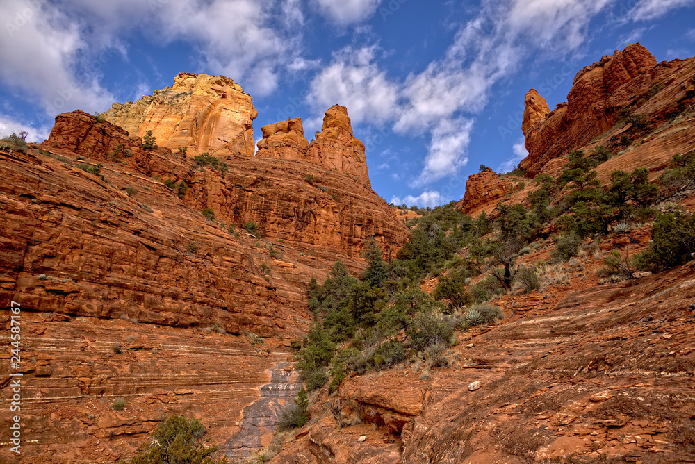 A view of Steamboat Rock on the right from its northeast flank. Just left of Steamboat is a rock formation referred to as the Captain and the Crew. Located in Sedona Arizona.