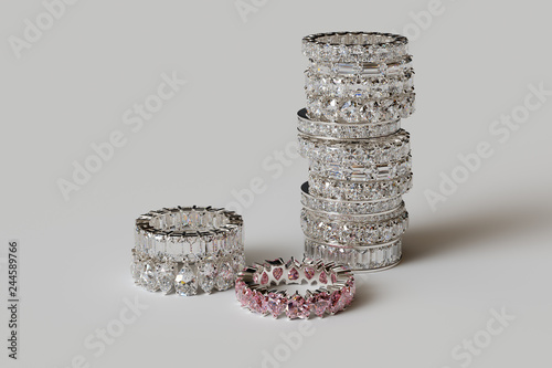 Stacked various diamond eternity rings on white background