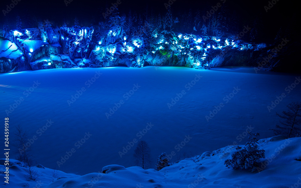 Illiminated Marble Canyon in Karelia in winter. Blue.