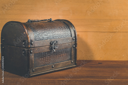 Old treasure box on wooden background antique