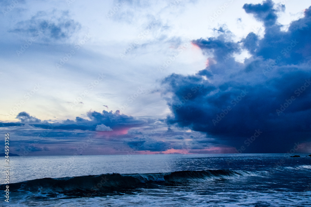 Naklejka premium Coloured sunset on Seyshells island. Sea, summer, cloud, sky