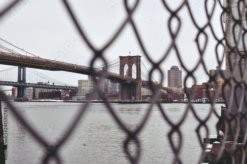 brooklyn bridge behind fence