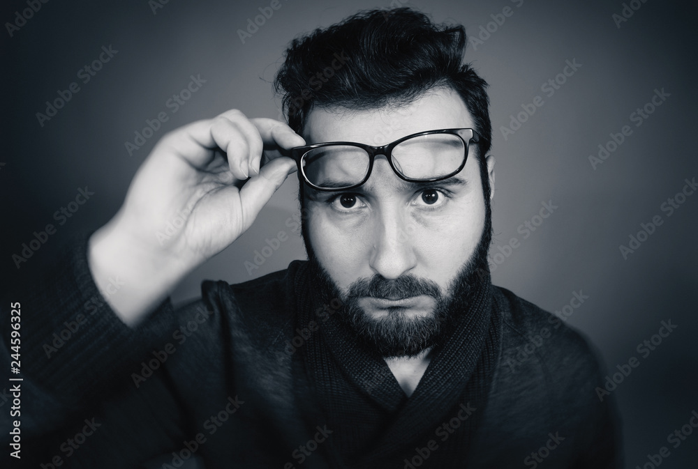 Black and white portrait of a serious man with glasses. Black and white portrait of a serious man with glasses.