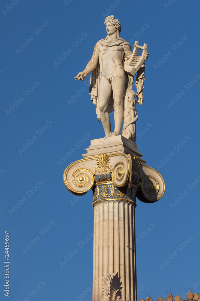 Sunset view of Statue of the ancient Greek god Apollo in front of Academy of Athens, Attica, Greece