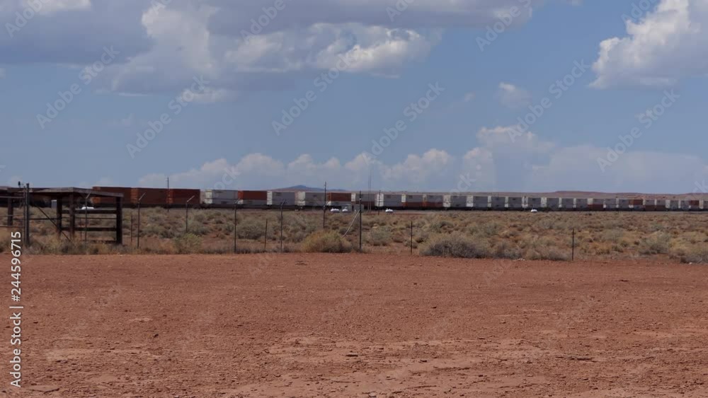 Train on railroad tracks near Meteor City, Arizona, United States of America. View of American desert landscape in the Southwest USA and railway transportation of goods Train on railroad tracks near Meteor City, Arizona, United States of America. View of American desert landscape in the Southwest USA and railway transportation of goods