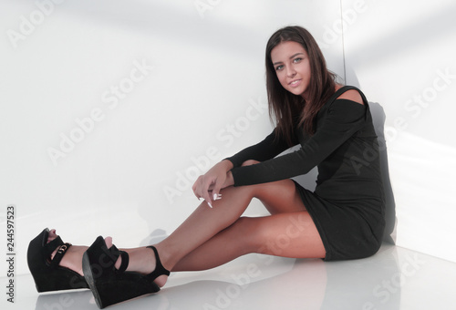 serious young woman sitting on the floor.