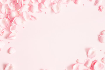 Flowers composition. Rose flower petals on pastel pink background. Valentines day, mothers day, womens day concept. Flat lay, top view, copy space