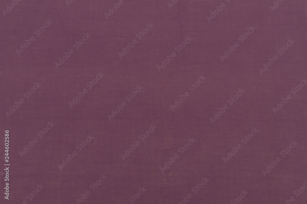 Fototapeta premium Close up bright purple cotton fabric texture background. Fashionable beautiful background. Selective focus. top view