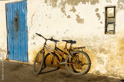 Old rustic vintage bicycle on the street near the color wall. Travel concept. Bike ride. Postcard. Copy space. photo