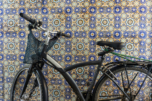 Old rustic vintage bicycle on the street near the color wall. Travel concept. Bike ride. Postcard. Copy space. photo