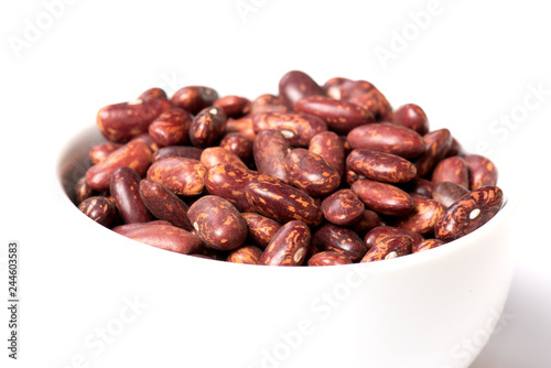 Pinto beans in a white cup close-up