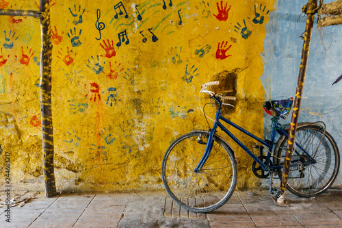 Old rustic vintage bicycle on the street near the color wall. Travel concept. Bike ride. Postcard. Copy space. photo