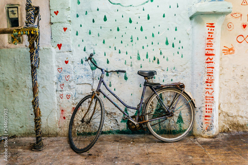 Old rustic vintage bicycle on the street near the color wall. Travel concept. Bike ride. Postcard. Copy space. photo