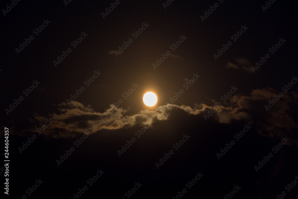 Moon through the clouds at night Moon through the clouds at night