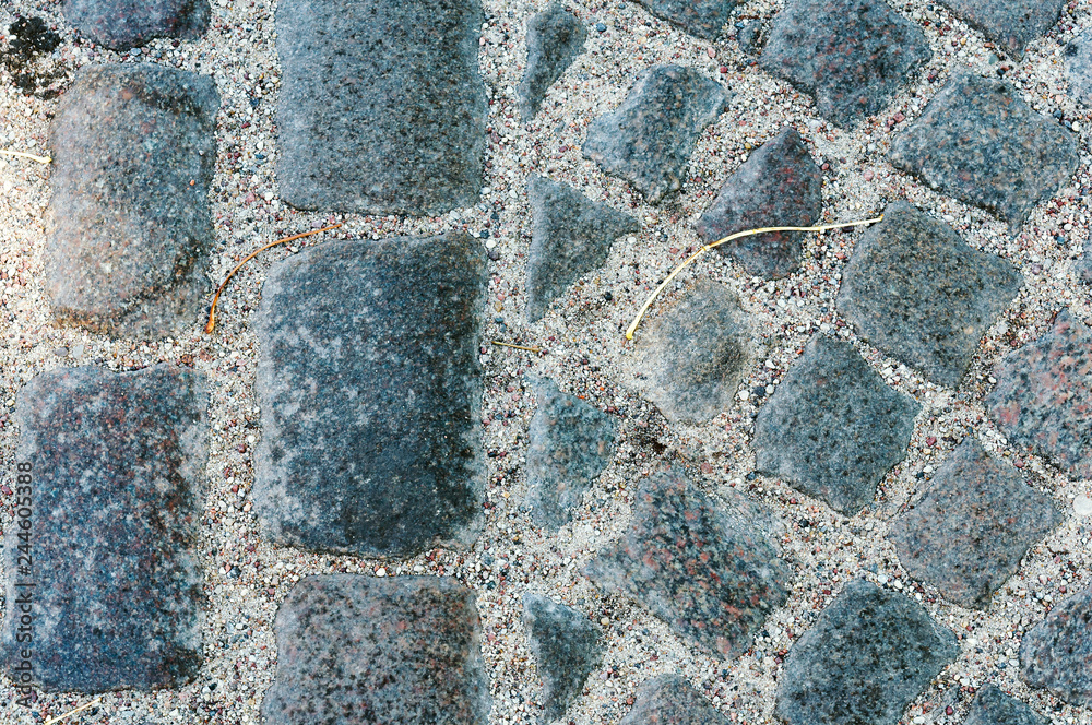 Fototapeta premium Cobblestones on the road. German paving stones. Neat paving stone.