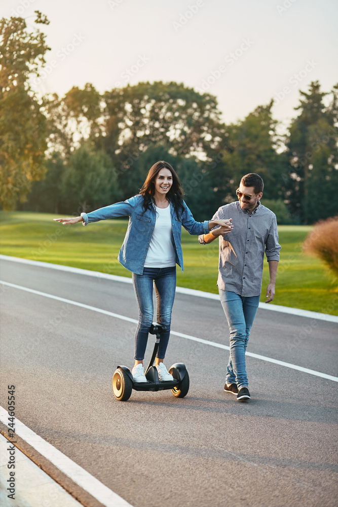 woman riding electric hoverboard on the road woman riding electric hoverboard on the road