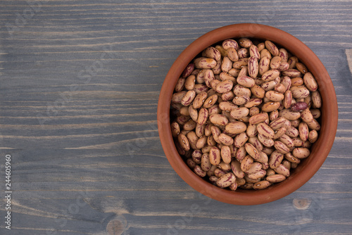 A plate of beans on wooden table background