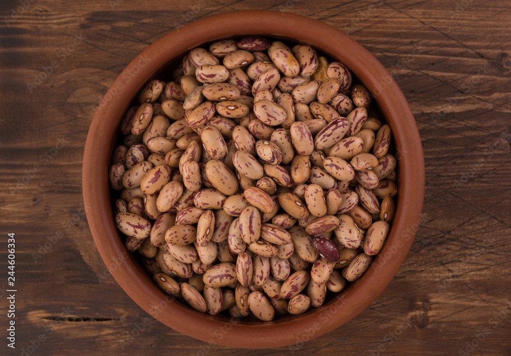 A plate of beans on wooden table background