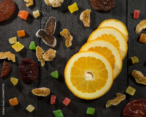 oranges and dried fruits on a dark background